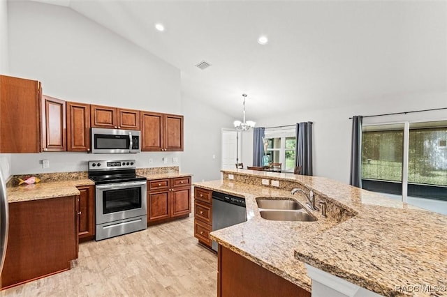 kitchen with stainless steel appliances, visible vents, an inviting chandelier, a sink, and light wood-type flooring