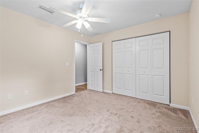 unfurnished bedroom with ceiling fan, carpet floors, visible vents, baseboards, and a closet