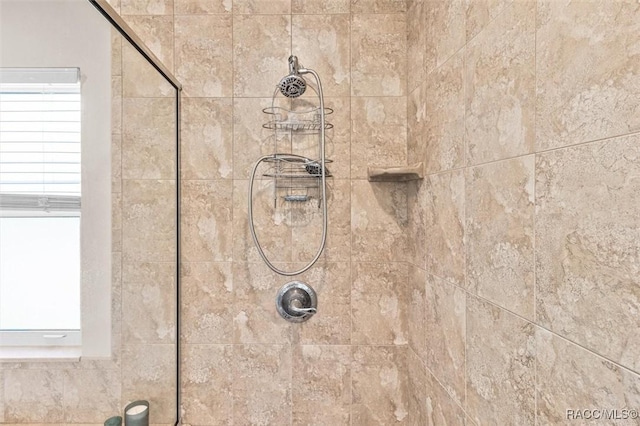 interior details featuring a tile shower