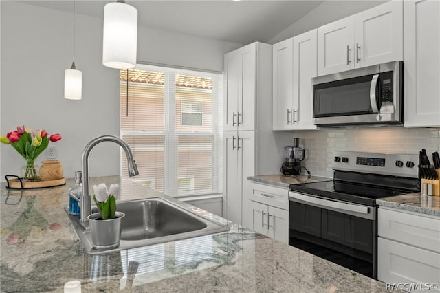 kitchen with appliances with stainless steel finishes, white cabinetry, and sink