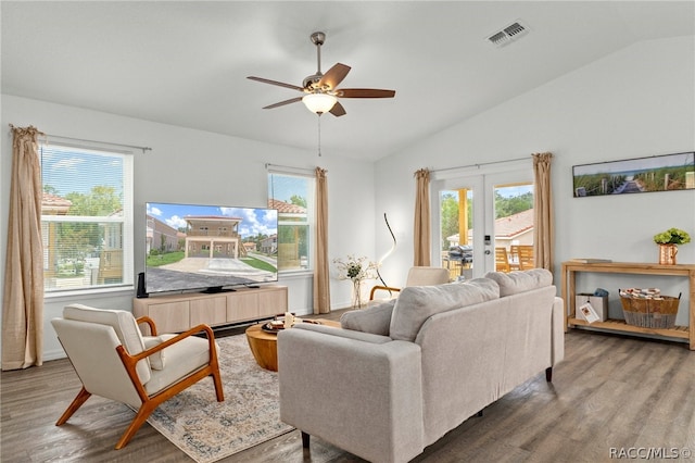 living room featuring ceiling fan, french doors, wood-type flooring, and vaulted ceiling