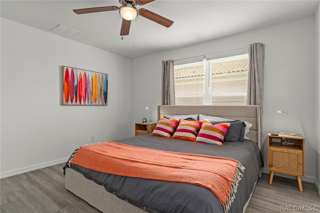 bedroom with hardwood / wood-style flooring and ceiling fan