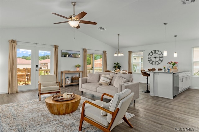 living room featuring a wealth of natural light, hardwood / wood-style floors, and lofted ceiling