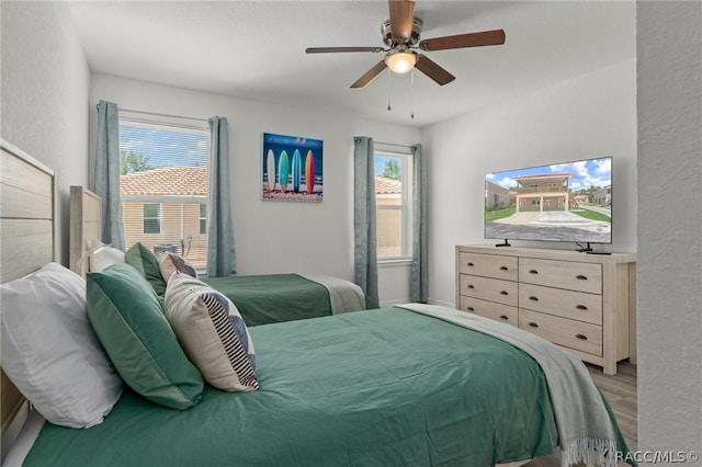 bedroom with hardwood / wood-style flooring and ceiling fan