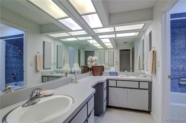 bathroom featuring tile patterned floors, vanity, and  shower combination