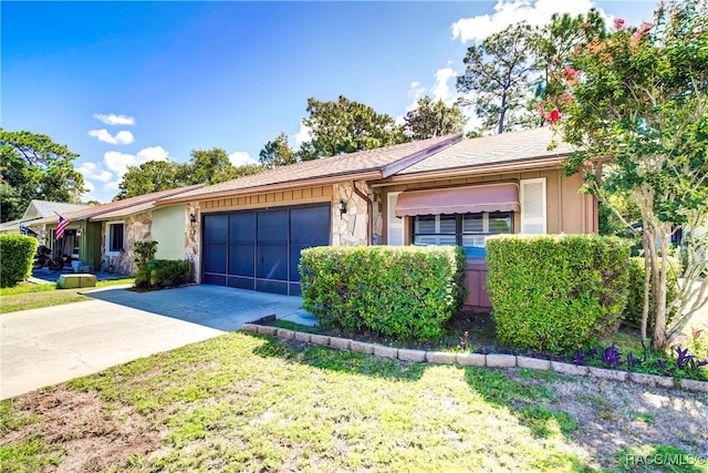 ranch-style home featuring a garage and a front lawn