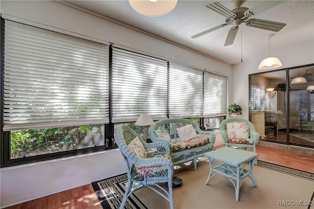 sunroom / solarium featuring ceiling fan