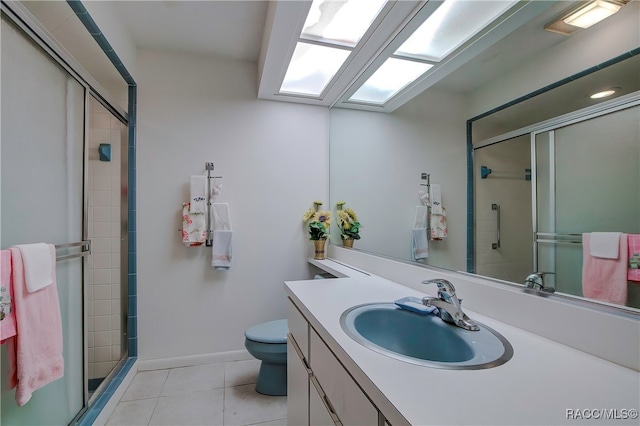 bathroom featuring toilet, vanity, tile patterned floors, and walk in shower