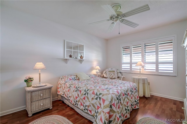 bedroom with dark hardwood / wood-style flooring and ceiling fan