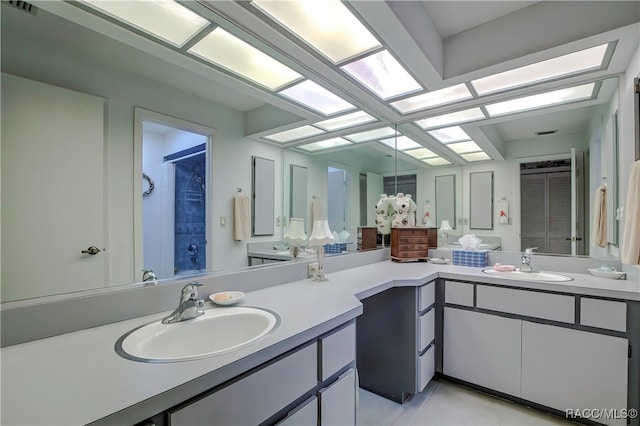 bathroom featuring tile patterned floors, vanity, and walk in shower