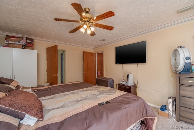 bedroom with ceiling fan, carpet floors, a textured ceiling, and ornamental molding