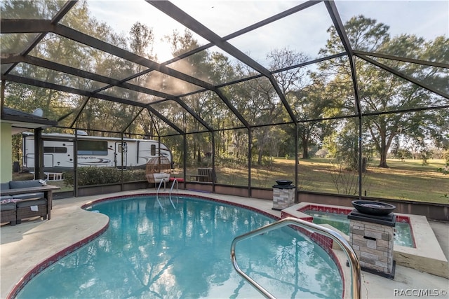 view of swimming pool with a patio area and a lanai