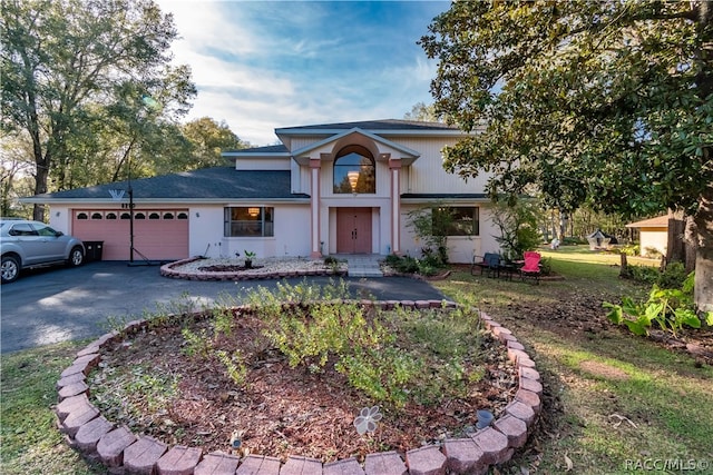 view of front of house featuring a front yard and a garage