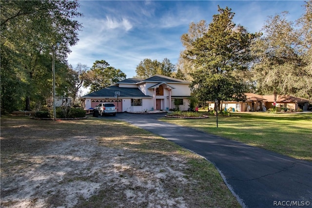 view of front of home featuring a garage and a front lawn