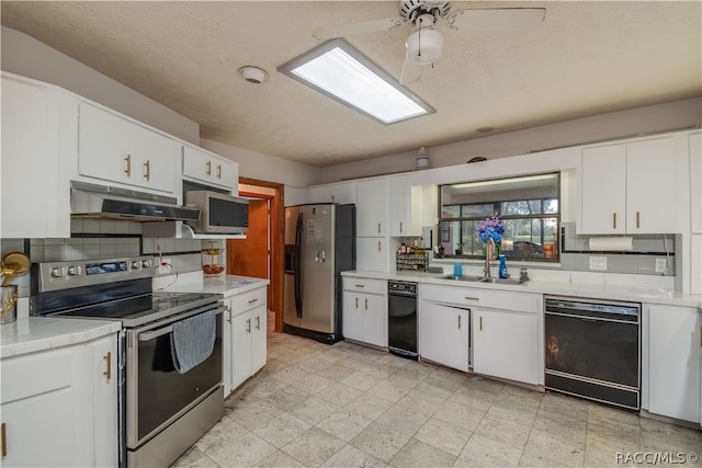 kitchen with backsplash, sink, white cabinets, and stainless steel appliances