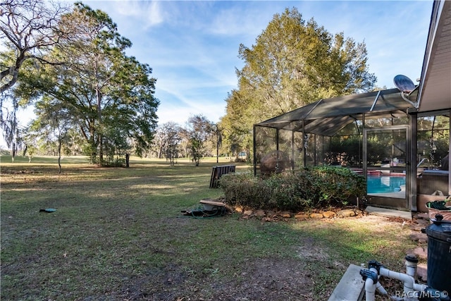 view of yard with glass enclosure