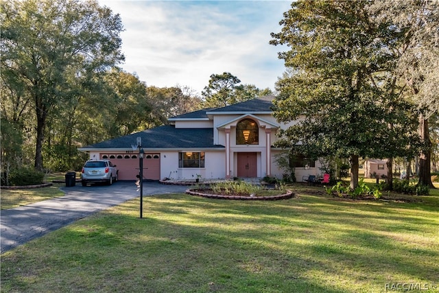 view of front of property with a garage and a front lawn