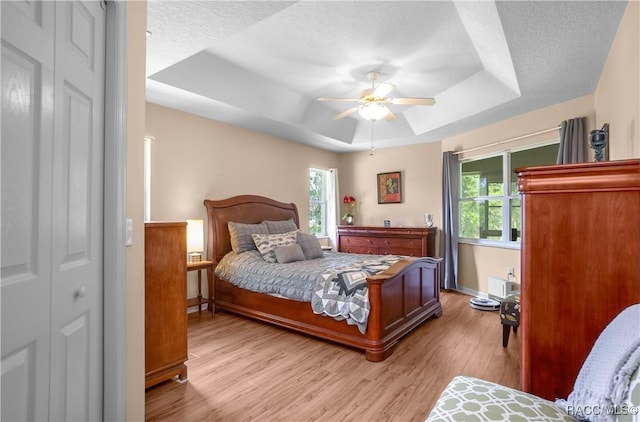 3339 E Axelford Ct, Hernando, FL 34442 - bedroom featuring a raised ceiling, multiple windows, light wood-style floors, and ceiling fan