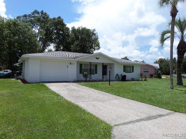 single story home featuring a garage and a front lawn