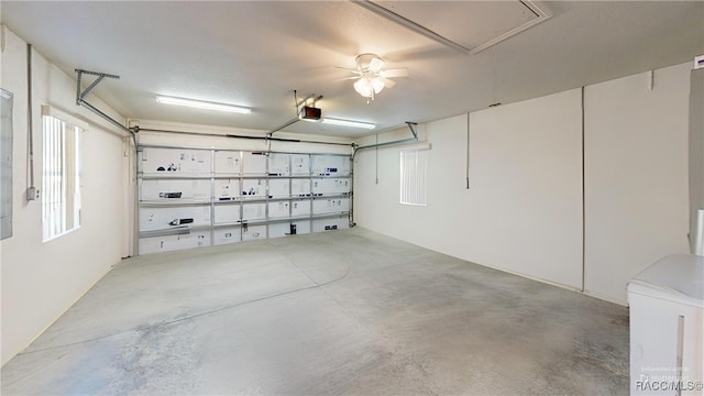 garage featuring ceiling fan and a garage door opener