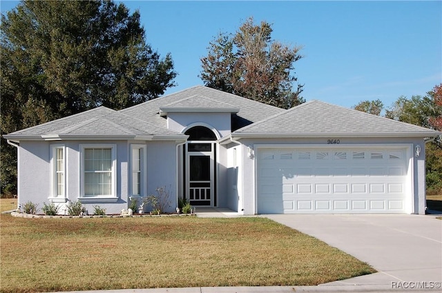 single story home featuring a front yard and a garage