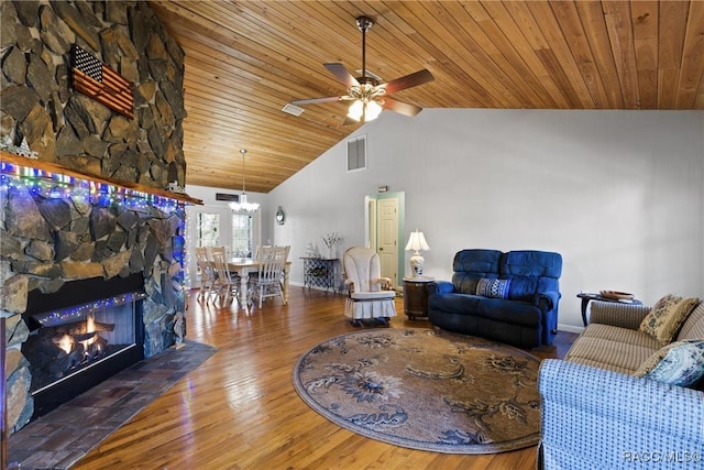 living room with visible vents, wooden ceiling, wood finished floors, and a ceiling fan