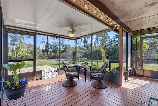 sunroom featuring ceiling fan