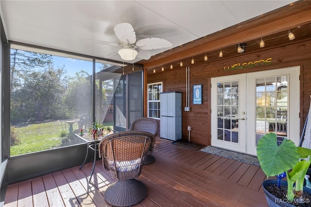 sunroom / solarium with french doors and a ceiling fan