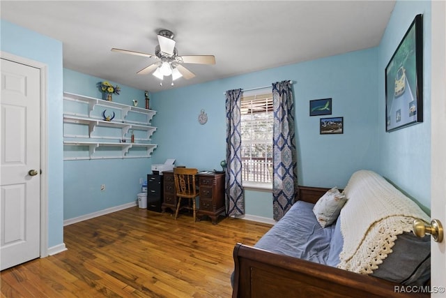 office area with baseboards, a ceiling fan, and wood finished floors