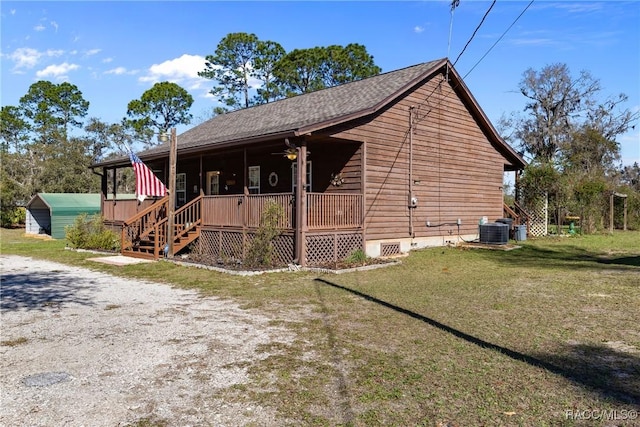 exterior space featuring crawl space, a yard, central AC unit, and driveway