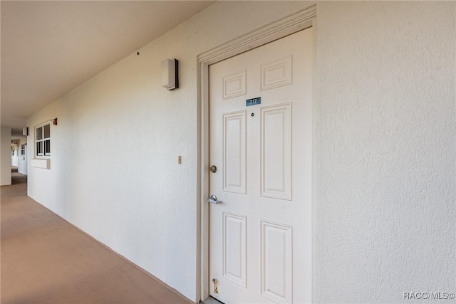 property entrance with stucco siding