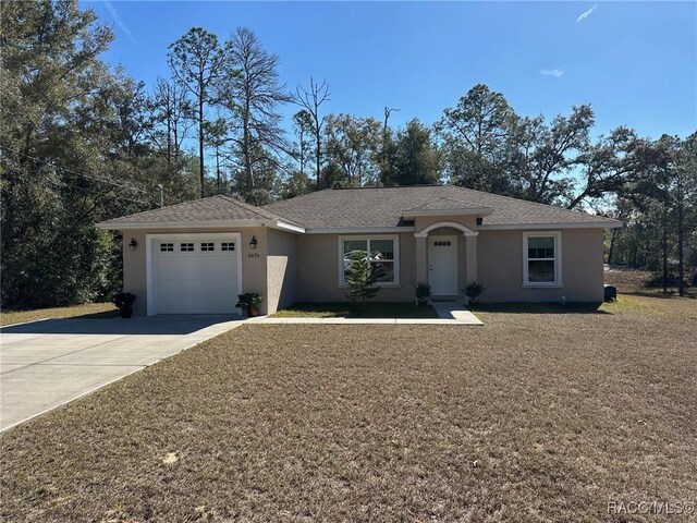 ranch-style home with central air condition unit and a garage