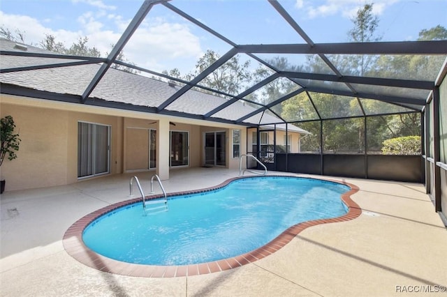 view of pool with a lanai and a patio