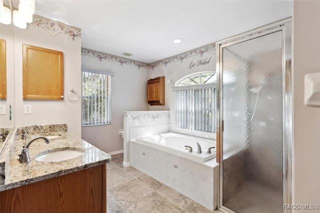 bathroom featuring vanity, shower with separate bathtub, and a wealth of natural light