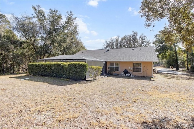 rear view of house featuring a lanai