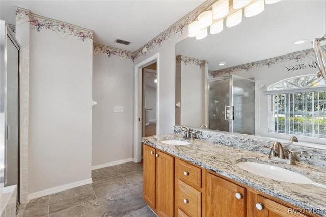 bathroom featuring vanity and a shower with shower door