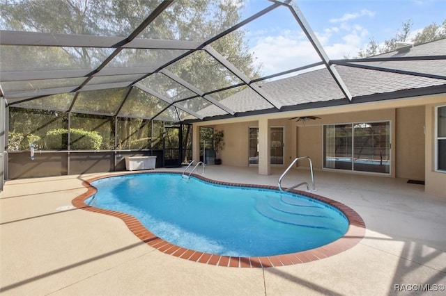 view of pool with a lanai, a patio, and ceiling fan