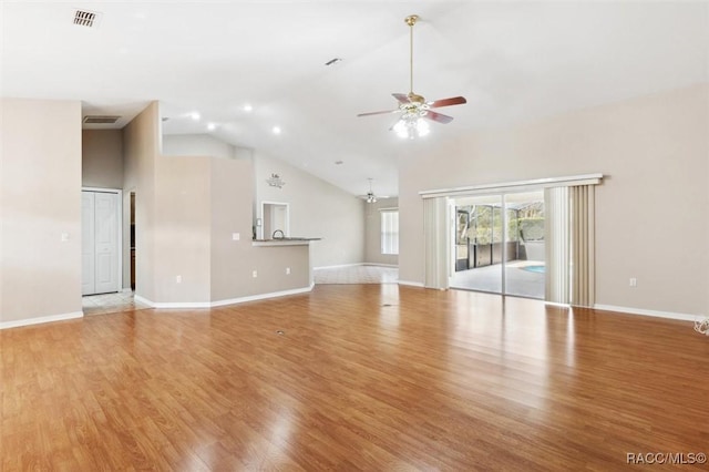 unfurnished living room with ceiling fan, high vaulted ceiling, and light hardwood / wood-style flooring