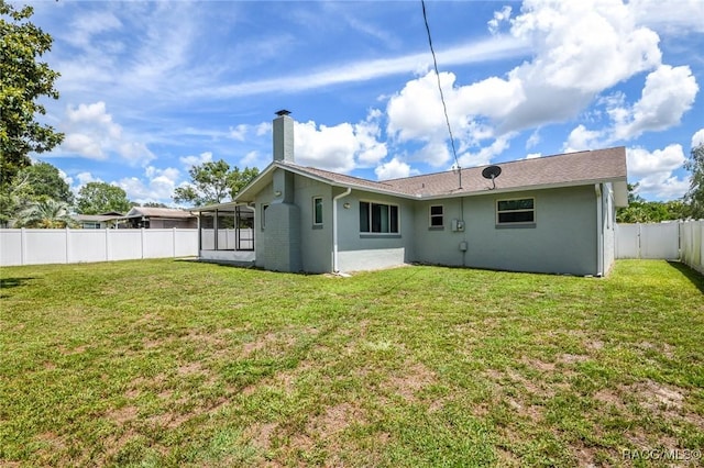 7 Michigan St, Beverly Hills, FL 34465 - rear view of house featuring a fenced backyard, a chimney, a sunroom, and stucco siding