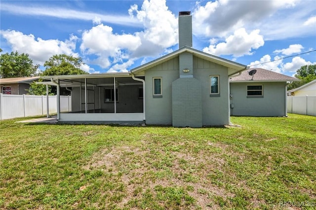 7 Michigan St, Beverly Hills, FL 34465 - rear view of house with a sunroom, a fenced backyard, and a chimney