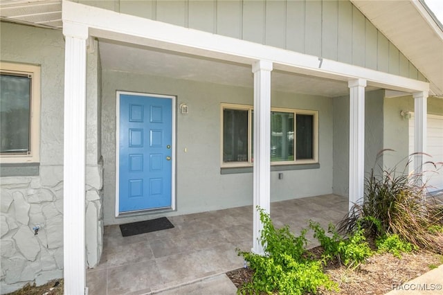 7 Michigan St, Beverly Hills, FL 34465 - view of exterior entry with a porch and stucco siding