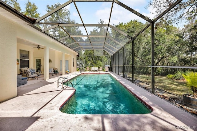 outdoor pool featuring a ceiling fan, a lanai, outdoor lounge area, and a patio