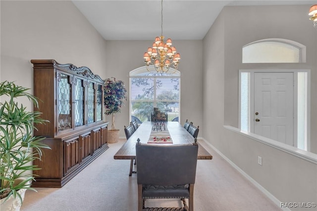 dining space with baseboards, a notable chandelier, and light colored carpet