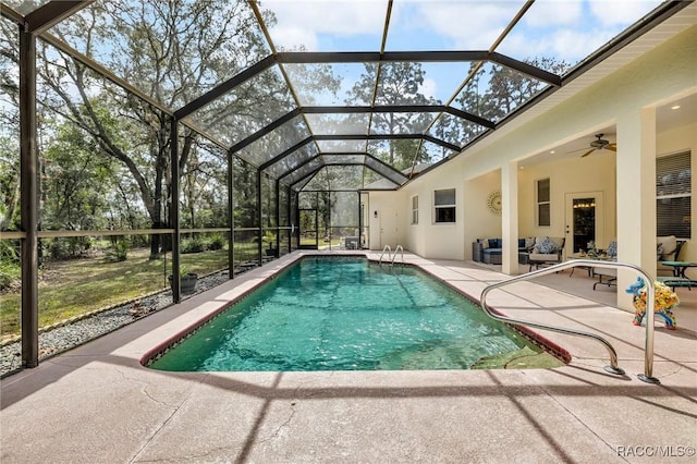 outdoor pool with ceiling fan, a patio, an outdoor hangout area, and glass enclosure