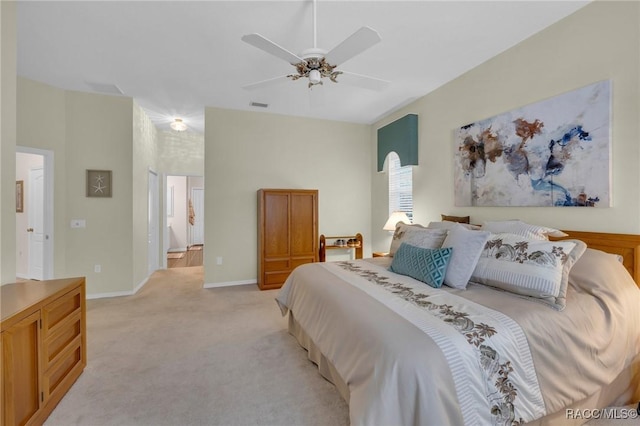 bedroom featuring connected bathroom, light colored carpet, a ceiling fan, baseboards, and visible vents