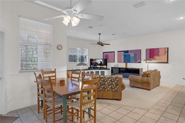 dining space with light tile patterned floors, ceiling fan, and visible vents