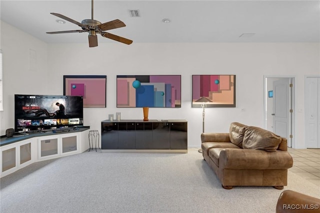 carpeted living area with visible vents and ceiling fan