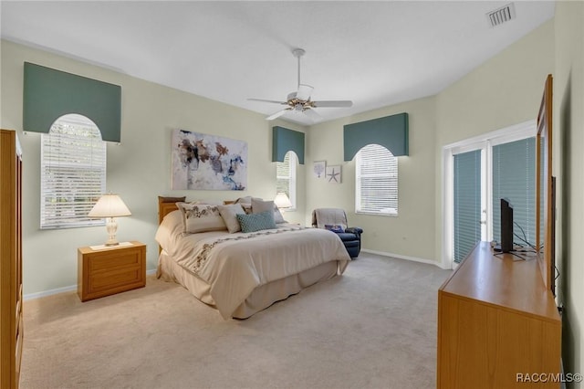 bedroom featuring access to exterior, visible vents, a ceiling fan, light carpet, and baseboards