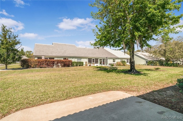 view of front of property with a front lawn and a tiled roof