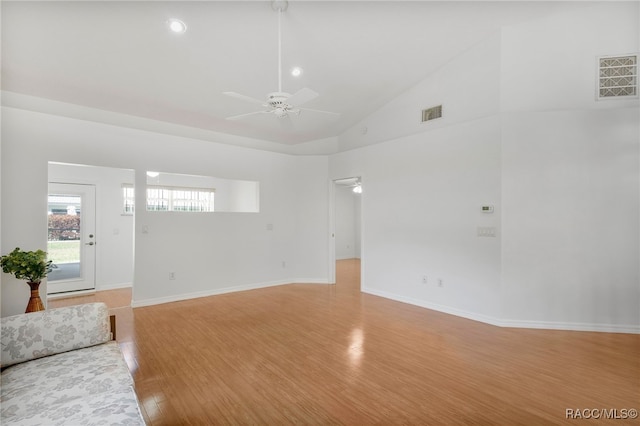 unfurnished living room featuring light wood-type flooring, baseboards, visible vents, and a ceiling fan